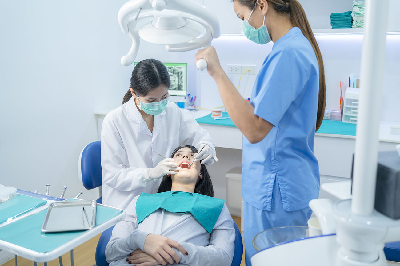 asian-dentist-adjust-dental-surgical-light-then-st-2021-12-09-02-20-54-utc.jpg
